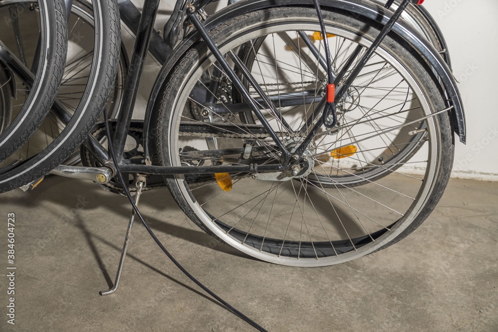 Close up view of two parked bicycles and one of them with flat tire. Healthy life style concept.