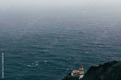 View of the foggy Atlantic ocean from the lighthouse of Azores Islands, Portugal