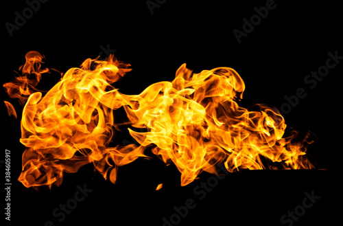 Fire flames on black background isolated. Burning gas or gasoline burns with fire and flames. Flaming burning sparks close-up, fire patterns. Infernal glow of fire in the dark with copy-space © Yevgeniy