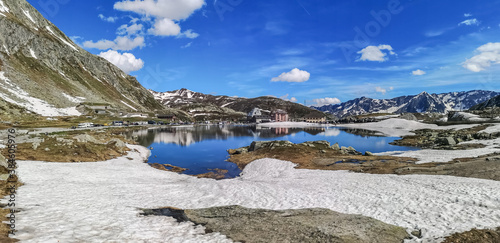 Ultra wide panorama of the lake in the Gotthardpass with snow