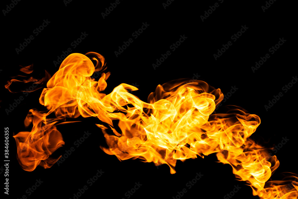 Fototapeta premium Fire flames on black background isolated. Burning gas or gasoline burns with fire and flames. Flaming burning sparks close-up, fire patterns. Infernal glow of fire in the dark with copy-space