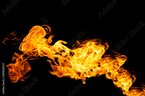 Fire flames on black background isolated. Burning gas or gasoline burns with fire and flames. Flaming burning sparks close-up, fire patterns. Infernal glow of fire in the dark with copy-space