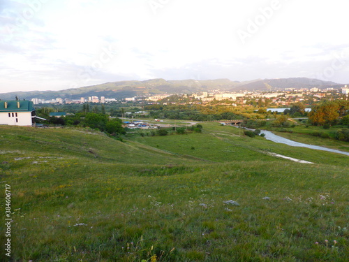 Grass, valley, horizon. View of the city of Kislovodsk