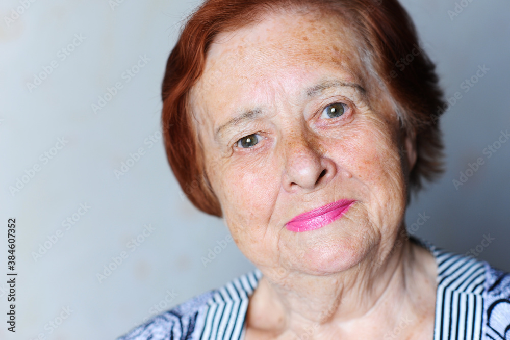 Smiling senior woman 70-80 year old posing over white background close up.Looking at camera. Wellness. Mature. Smiling senior woman 70-80 year old posing over white background close up.Looking at camera. Wellness. Mature.