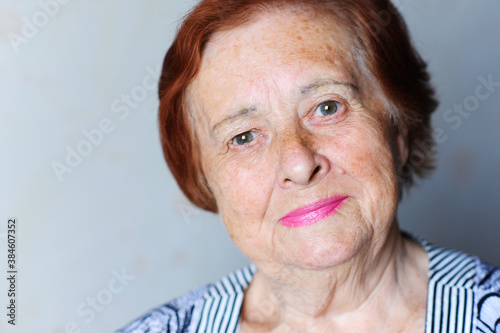 Smiling senior woman 70-80 year old posing over white background close up.Looking at camera. Wellness. Mature.