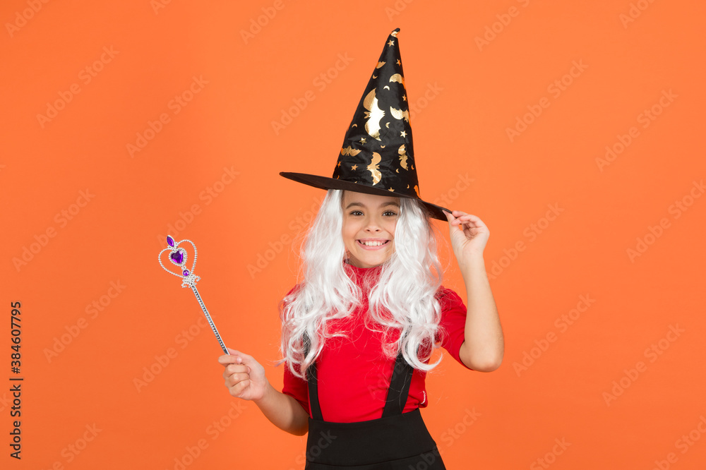 happy witch child with magic wand wear costume of wizard on halloween party, halloween magic