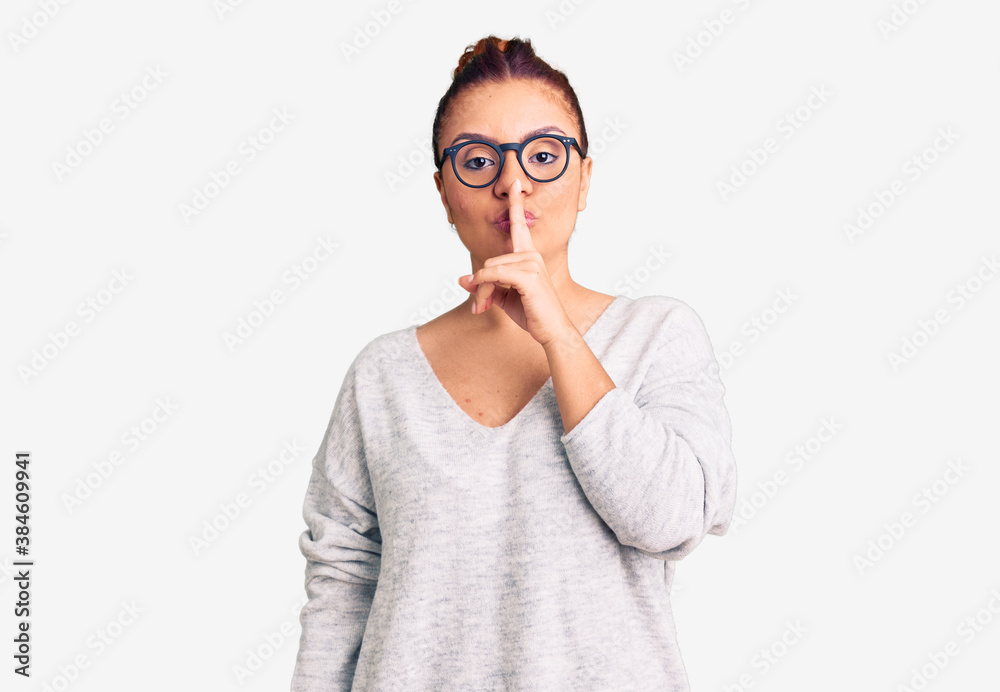 Young latin woman wearing casual clothes asking to be quiet with finger on lips. silence and secret concept. Young latin woman wearing casual clothes asking to be quiet with finger on lips. silence and secret concept.