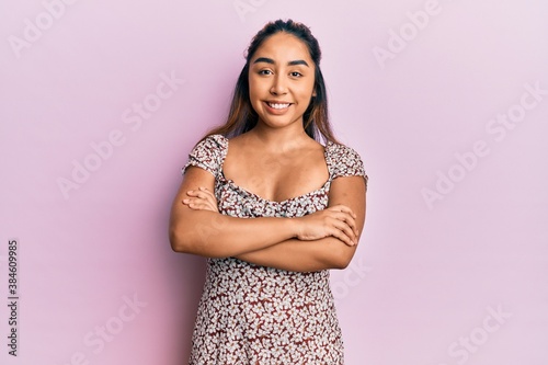 Young latin woman wearing casual clothes happy face smiling with crossed arms looking at the camera. positive person.