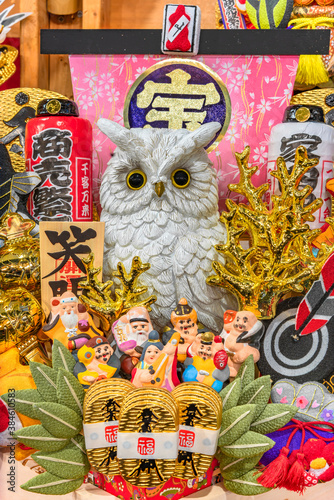 asakusa  japan - november 08 2019  Auspicious rake of Tori-no-Ichi Fair decorated with lucky charms like owl  golden coral koban coin fortune mallet or seven lucky gods for having success in business.