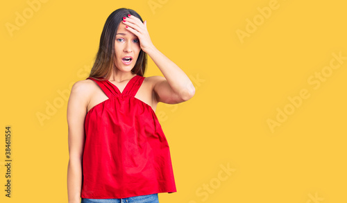 Beautiful brunette young woman wearing casual clothes surprised with hand on head for mistake, remember error. forgot, bad memory concept. © Krakenimages.com