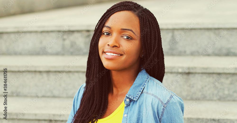 Fototapeta premium Portrait of happy young smiling african woman in casual over background