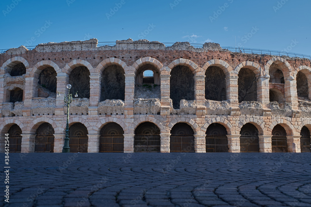 Antique Roman amphitheater in Verona, Italy. (Arena di Verona) blue sky in the background.