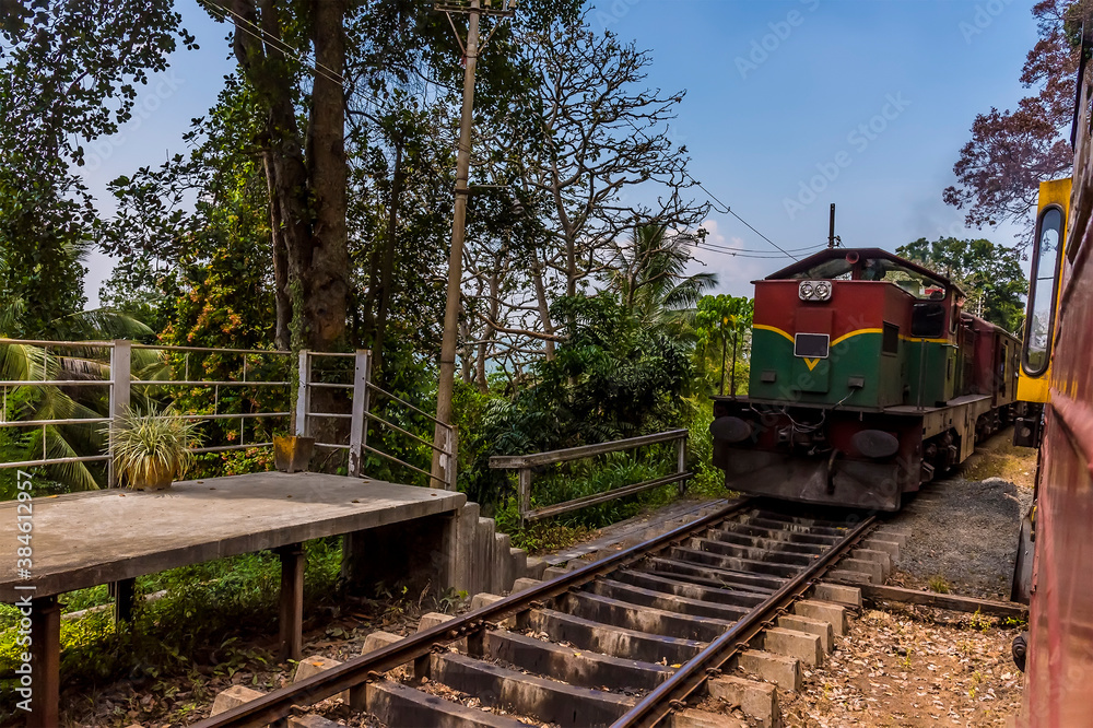 Trains passing at the station at Yatiwaldeniya on the Kandy to Colombo main line railway in Sri Lanka, Asia