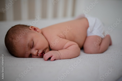 Newborn Baby Girl Sleeping Face Down in Her White Cradle
