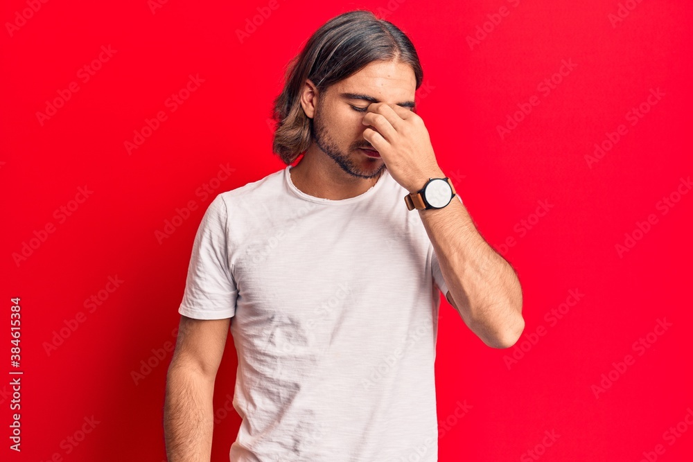 Young handsome man wearing casual clothes tired rubbing nose and eyes feeling fatigue and headache. stress and frustration concept. Young handsome man wearing casual clothes tired rubbing nose and eyes feeling fatigue and headache. stress and frustration concept.