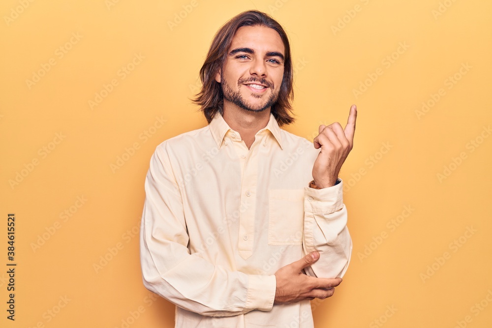 Young handsome man wearing business clothes with a big smile on face, pointing with hand and finger to the side looking at the camera. Young handsome man wearing business clothes with a big smile on face, pointing with hand and finger to the side looking at the camera.