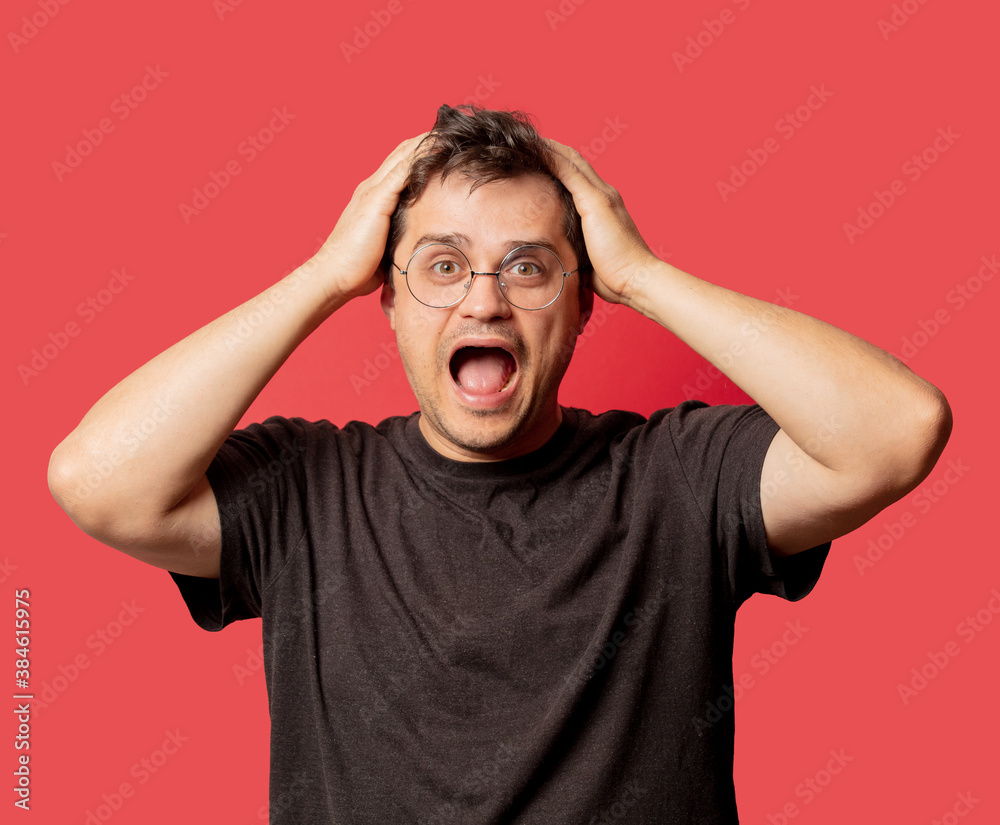 surprised man in glasses and shirt on red background surprised man in glasses and shirt on red background