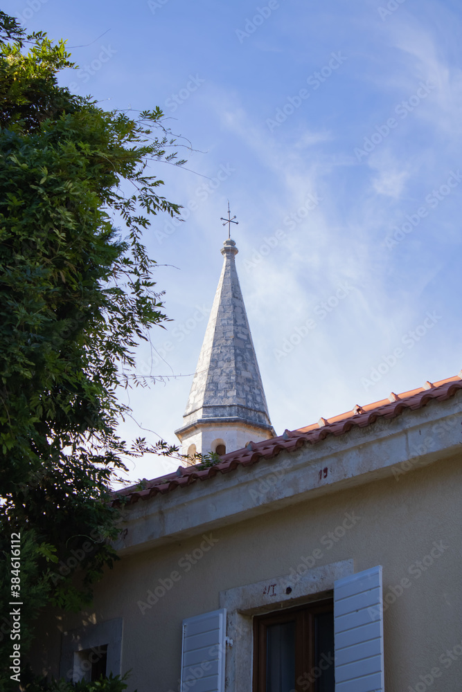 Church on a sunny day. The dome of the church with a cross against the blue sky.