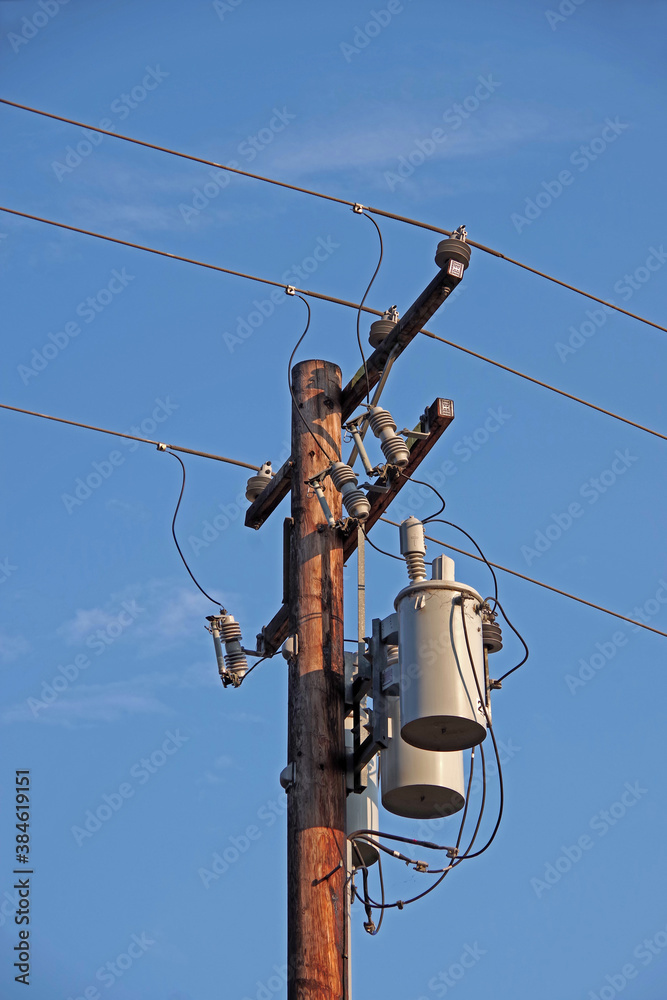 Low angle close view of the upper part of an Electricity Distribution Pylon in the evening sun Low angle close view of the upper part of an Electricity Distribution Pylon in the evening sun