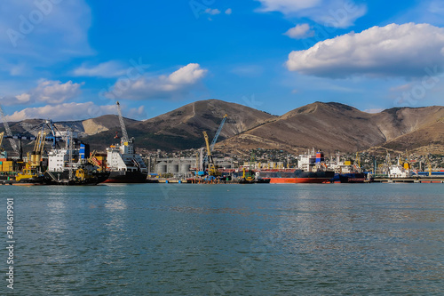 Sea ships stand in port of Novorossiysk at sunny day. Sea ships and the mountains. © Алекс Швачко