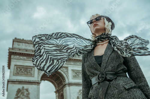 Canvas Print Outdoor autumn fashion portrait of elegant, luxury lady wearing trendy black boucle blazer, wide leather belt, animal, zebra print silk scarf, posing near Triumphal Arch in Paris