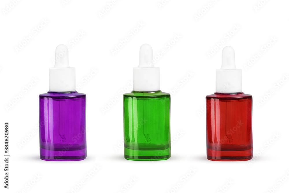 multicolored glass bottles with pipette on white background