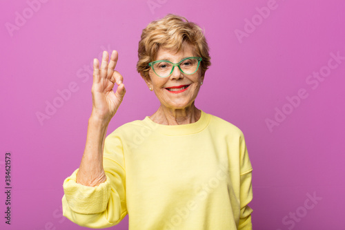 Fotografie old pretty woman feeling successful and satisfied, smiling with mouth wide open,