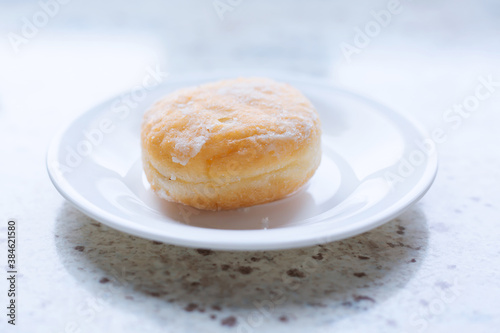 Delicious sugar donut on a white plate