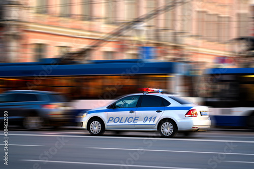 police driving on the road, blurred background from speed © John