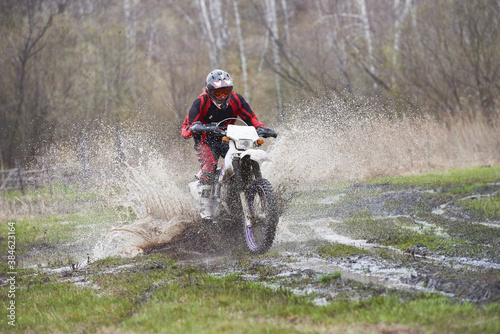 Motorcross rider racing in mud track