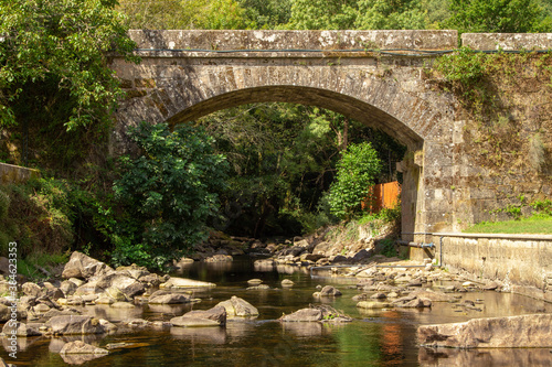 old bridge over the bubal river in os peares, ourense, galicia, spain photo