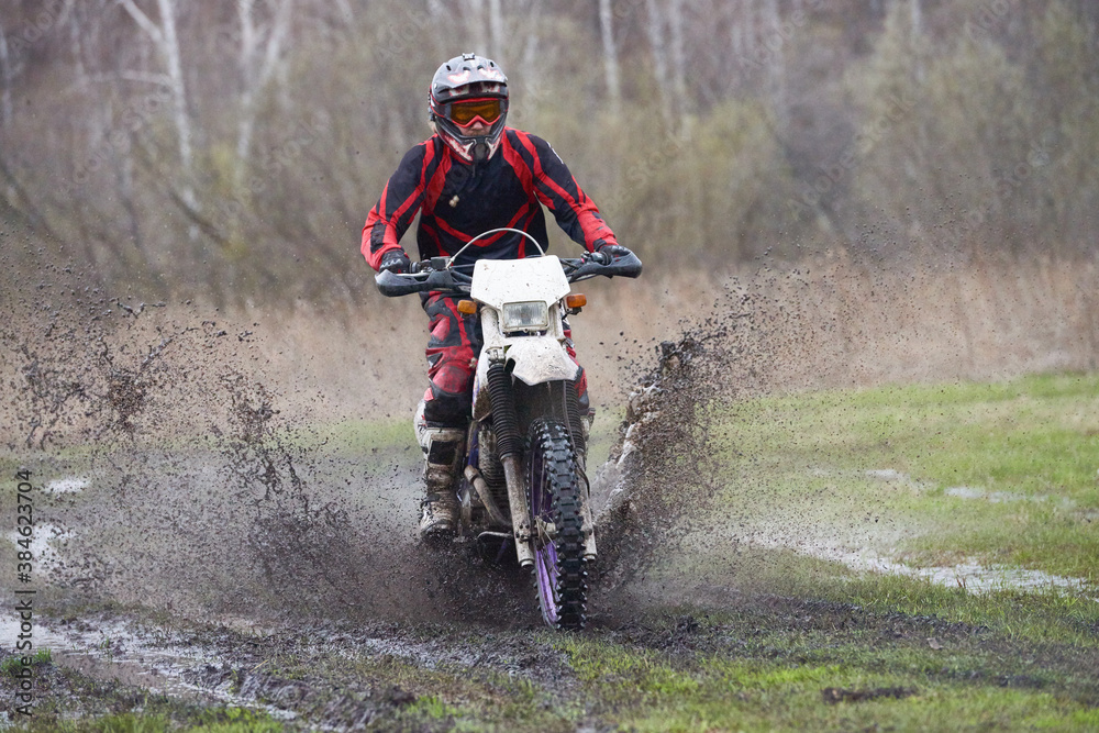Motorcross cyclist racing in rural area Motorcross cyclist racing in rural area