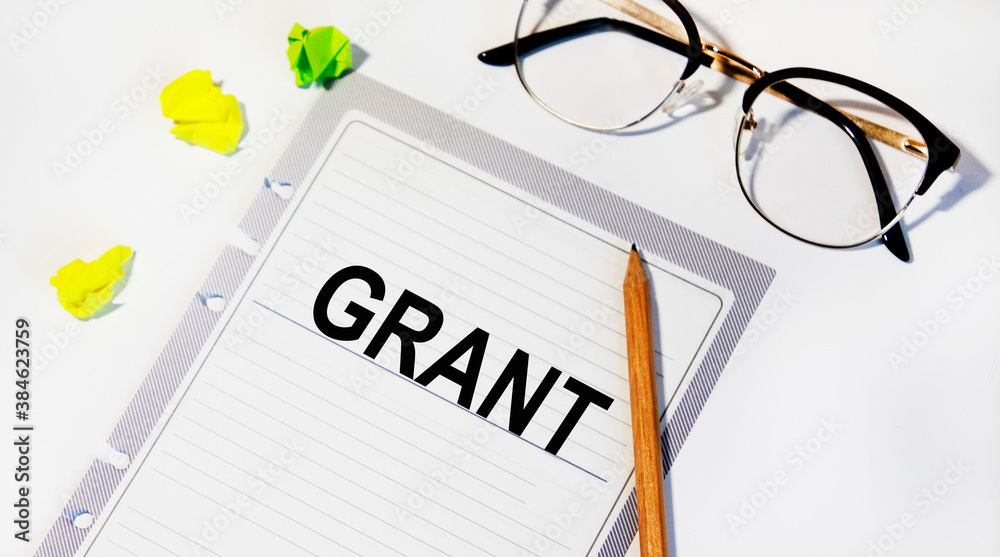 On a sheet from the diary is a GRANT inscription, next to a pencil, glasses and sheets for notes. On a sheet from the diary is a GRANT inscription, next to a pencil, glasses and sheets for notes.