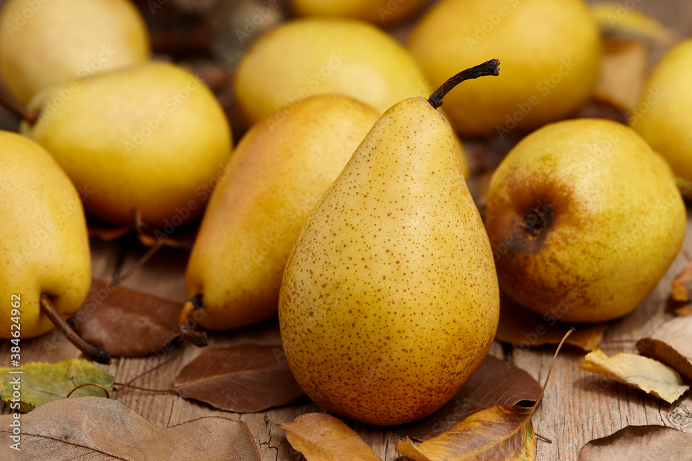 Yellow pears on wooden table, close up view