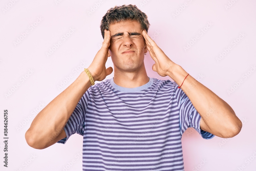 Young handsome man wearing casual clothes with hand on head, headache because stress. suffering migraine. Young handsome man wearing casual clothes with hand on head, headache because stress. suffering migraine.