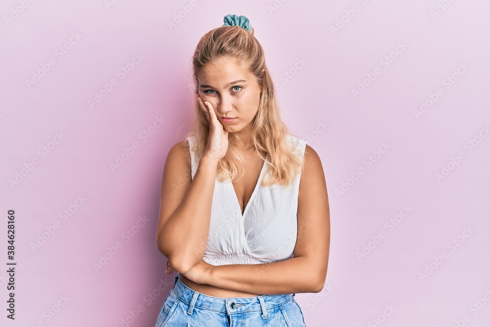 Young blonde girl wearing casual clothes thinking looking tired and bored with depression problems with crossed arms. Young blonde girl wearing casual clothes thinking looking tired and bored with depression problems with crossed arms.