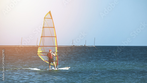 Recreational Water Sports. Windsurfing. Windsurfer Surfing The Wind On Waves In Ocean, Sea. High quality photo