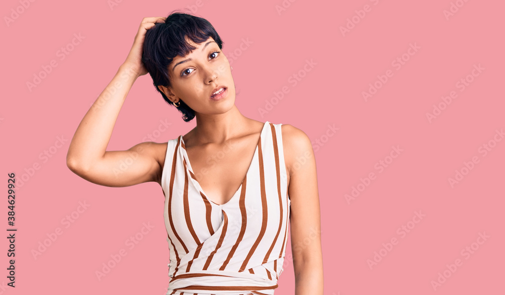 Young brunette woman with short hair wearing summer outfit confuse and wonder about question. uncertain with doubt, thinking with hand on head. pensive concept. Young brunette woman with short hair wearing summer outfit confuse and wonder about question. uncertain with doubt, thinking with hand on head. pensive concept.