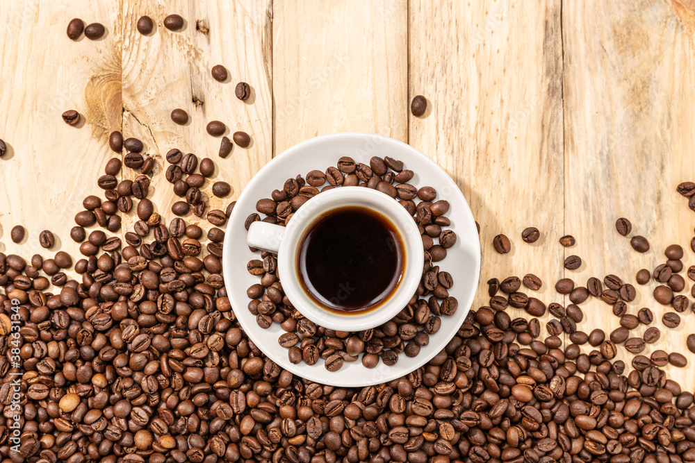 Cup of Espresso Coffee and roasted beans on wooden table background Cup of Espresso Coffee and roasted beans on wooden table background