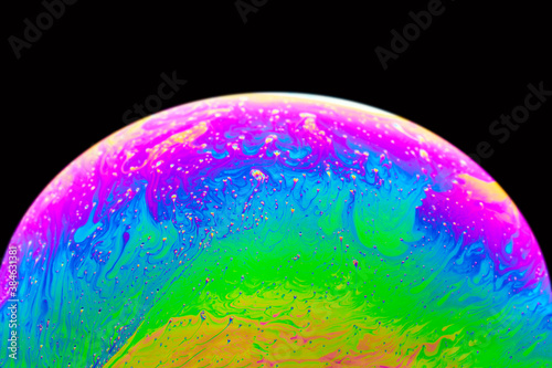 Soap bubble close up macro abstraction and planet imitation. Abstract background with colorful gradient colors.