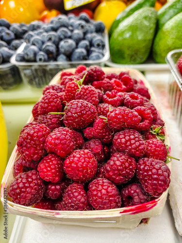 Raspberries are on the counter in the supermarket