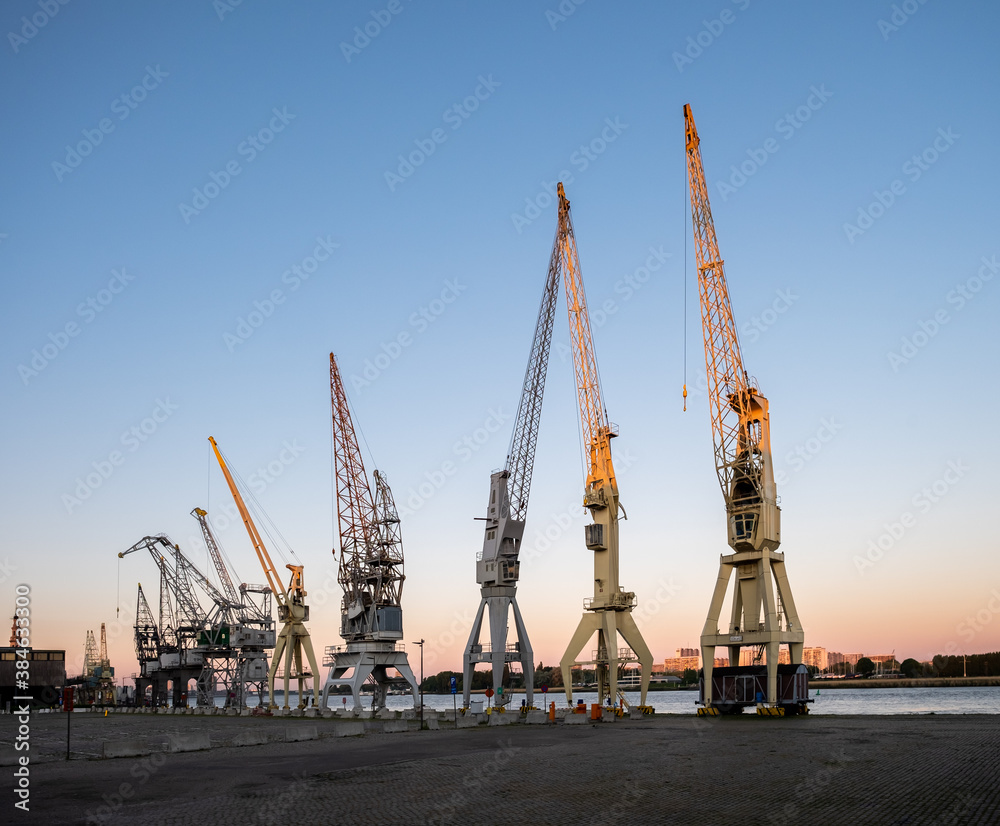 Old harbor cranes in early morning sunlight. The cranes are part of the collection of the MAS museum.