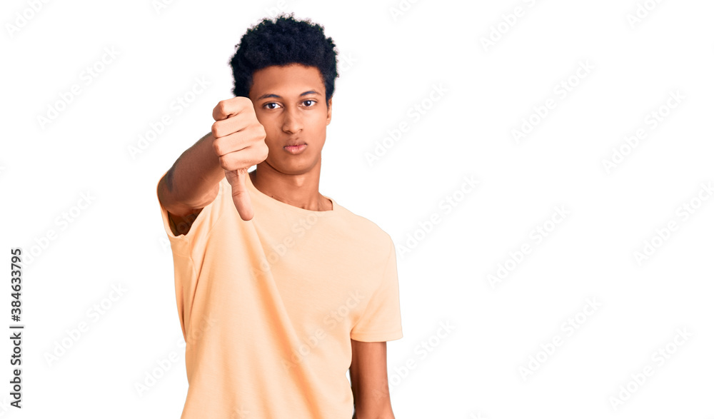 Young african american man wearing casual clothes looking unhappy and angry showing rejection and negative with thumbs down gesture. bad expression. Young african american man wearing casual clothes looking unhappy and angry showing rejection and negative with thumbs down gesture. bad expression.