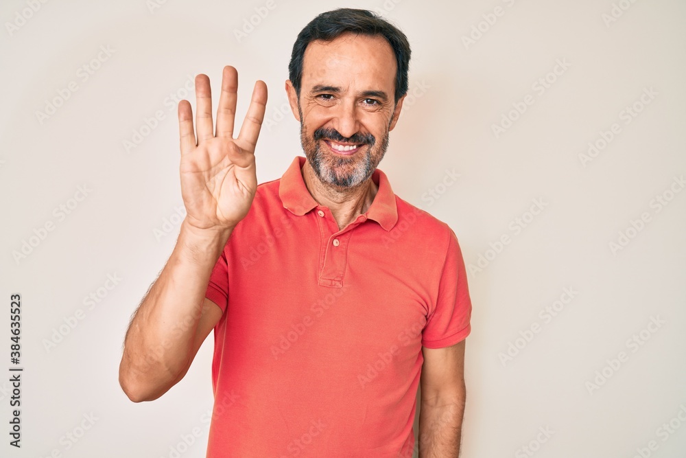 Middle age hispanic man wearing casual clothes showing and pointing up with fingers number four while smiling confident and happy. Middle age hispanic man wearing casual clothes showing and pointing up with fingers number four while smiling confident and happy.