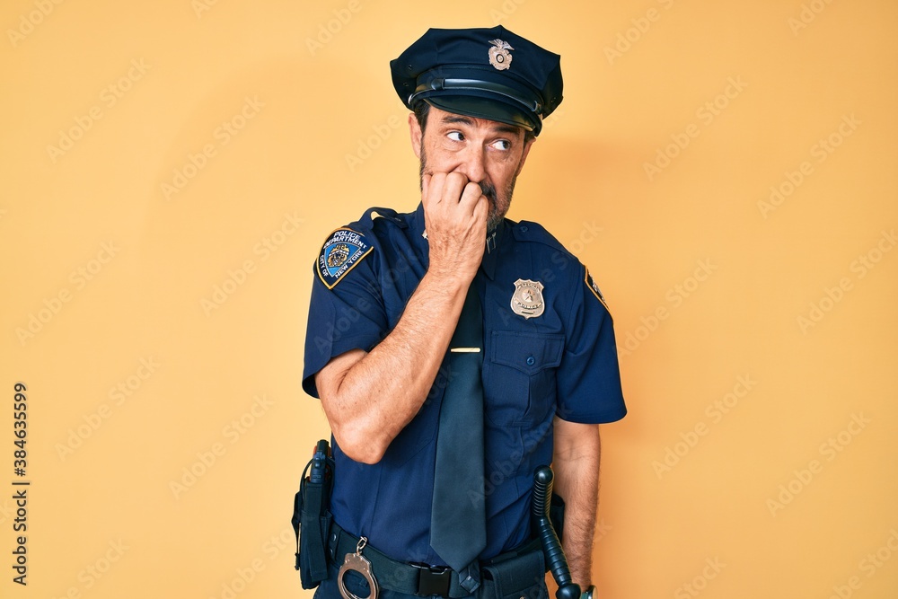 Middle age hispanic man wearing police uniform looking stressed and nervous with hands on mouth biting nails. anxiety problem.