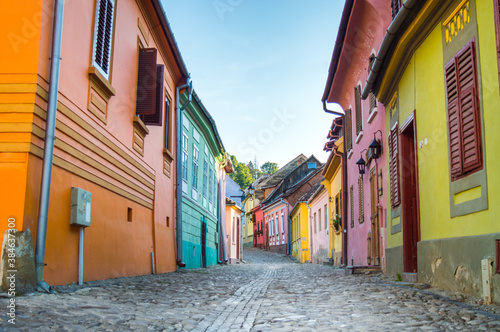 Colorful houses on street in Sighisoara, Romania © Dragos