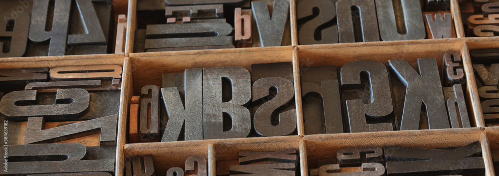 Old letterpess background. Collection of vintage block letters made of