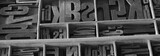Old letterpess background. Collection of vintage block letters made of wood