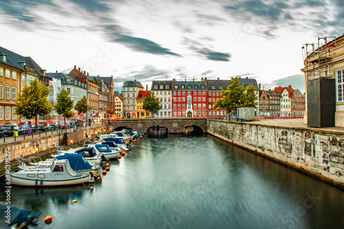 Early morning shot of a city canal with small boats and colorful houses in Copenhagen, Denmark, nybrogade, Holmanskanal