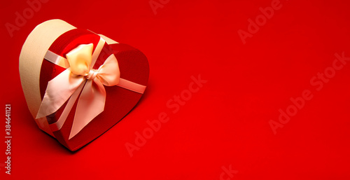 Red heart shape gift box on red background